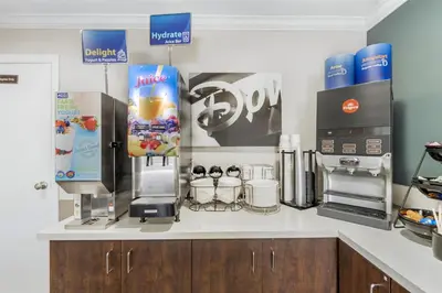 a kitchen with a counter top with a coffee machine at Best Western Courtesy Hotel - Anaheim Resort Amusement Park in Anaheim