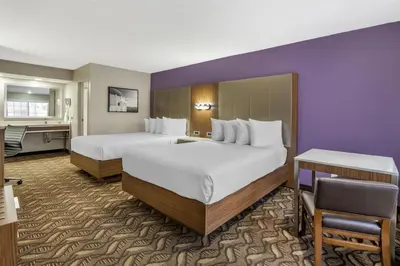 a hotel room with two beds and a desk at Best Western Airport Plaza Hotel – LAX Airport LA Stadium in Los Angeles