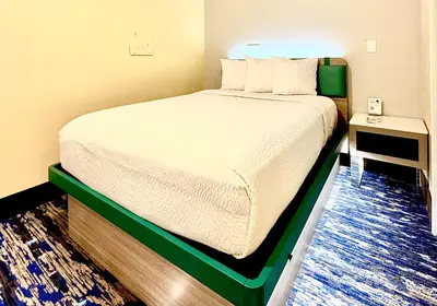 a bed in a small room with a white bed sidx sidx sidx at Days Inn by Wyndham Los Angeles LAX Airport Stadium Area in Los Angeles