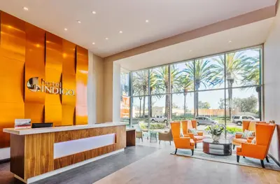 a lobby of a hotel indio with orange chairs at Hotel Indigo Anaheim by IHG in Anaheim