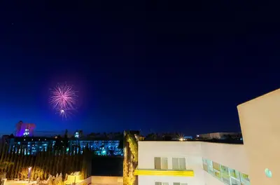 a firework in the sky over a city at night at Hotel Indigo Anaheim by IHG in Anaheim