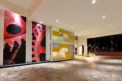 a lobby with colorful paintings on the walls at Hotel Indigo Anaheim by IHG in Anaheim