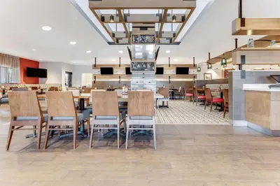 a dining area with tables and chairs in a restaurant at Sonesta Anaheim Resort Area in Anaheim