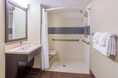 a bathroom with a sink and a shower at Sonesta ES Suites Anaheim Resort Area in Anaheim
