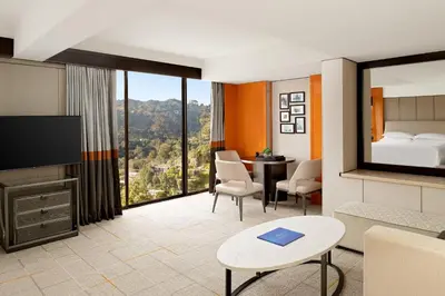 a hotel room with a bed and a room with a view at Sheraton Universal in Los Angeles