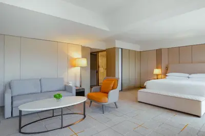 a bedroom with a bed and a couch and a table at Sheraton Universal in Los Angeles