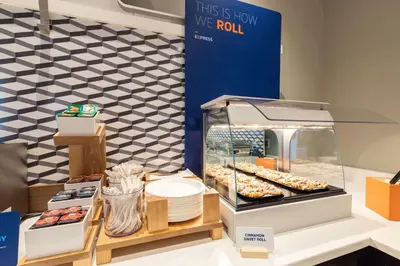 a display case with donuts and other pastries at Holiday Inn Express Los Angeles LAX Airport by IHG in Los Angeles