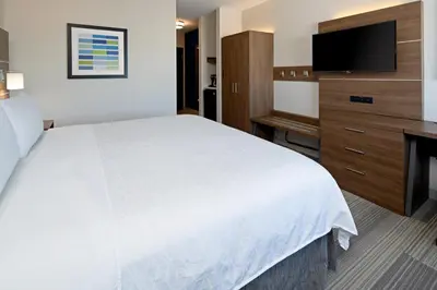 a hotel room with a bed and a flat screen tv at Holiday Inn Express Los Angeles LAX Airport by IHG in Los Angeles