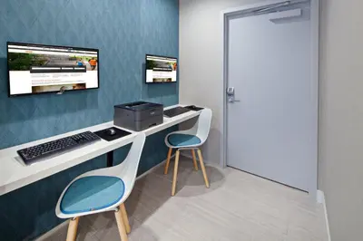 a room with a desk with a computer and two chairs at Holiday Inn Express Hollywood Walk of Fame by IHG in Los Angeles