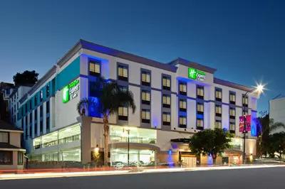a building with neon signs on the side of it at Holiday Inn Express Hollywood Walk of Fame by IHG in Los Angeles