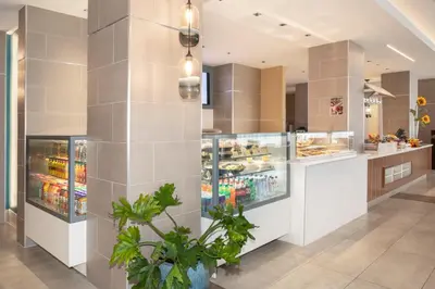 a grocery store with a food counter in a building at Holiday Inn Los Angeles - LAX Airport by IHG in Los Angeles