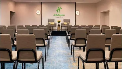 a room with rows of chairs and a podium at Holiday Inn Los Angeles - LAX Airport by IHG in Los Angeles