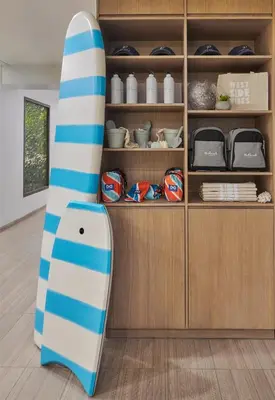 a surfboard is standing next to a shelf at The Pierside Santa Monica in Los Angeles
