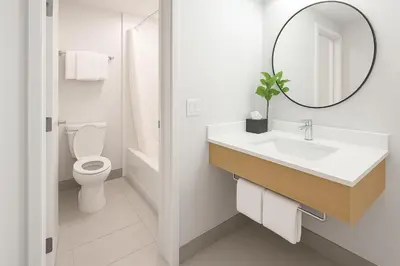 a bathroom with a sink and a toilet and a mirror at The Live Hotel in Los Angeles