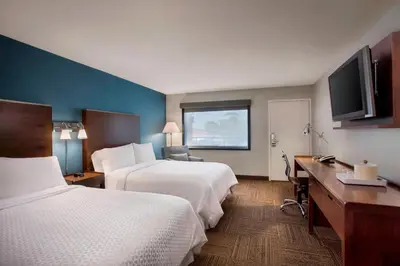 a hotel room with two beds and a flat screen tv at Four Points by Sheraton Anaheim in Anaheim