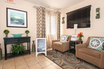 a living room with a couch and a chair at Sonesta Simply Suites Anaheim in Anaheim