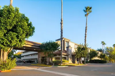 a building with palm trees on the side of a street at Holiday Inn Express Simi Valley by IHG in Simi Valley