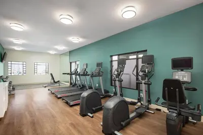 a gym with a row of treadmills and exercise bikes at Holiday Inn Express Hotel & Suites Ventura Harbor by IHG in Ventura