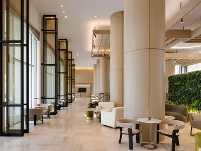 a lobby with chairs and tables in a building at Fairmont Century Plaza Los Angeles at Beverly Hills in Los Angeles