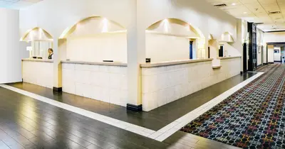 a lobby of a building with mirrors and a rug at Hotel Burbank in Burbank