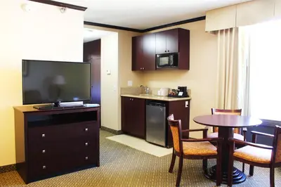 a hotel room with a kitchen and a table and a television at Hotel Burbank in Burbank