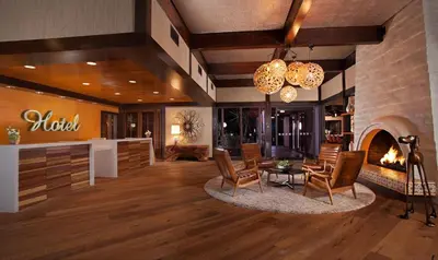 a lobby with chairs and a table and a fireplace at The Garland in Los Angeles