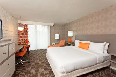 a hotel room with a large bed and a desk at The Garland in Los Angeles
