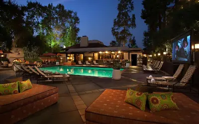 a swimming pool with lounge chairs and a restaurant at The Garland in Los Angeles