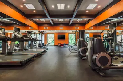 a gym with treadmills and elliptical machines at The Garland in Los Angeles