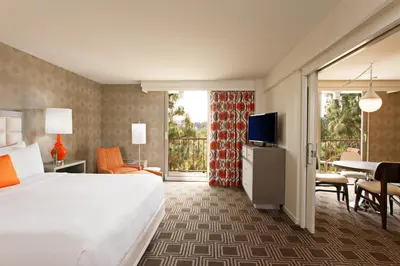 a hotel room with a bed and a television at The Garland in Los Angeles