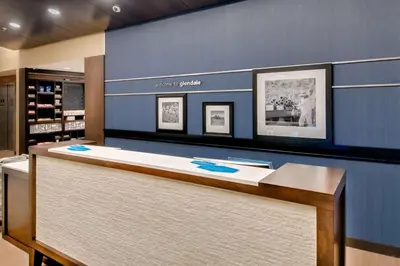 a reception desk in a store with a blue wall at Hampton Inn & Suites Los Angeles - Glendale in Glendale