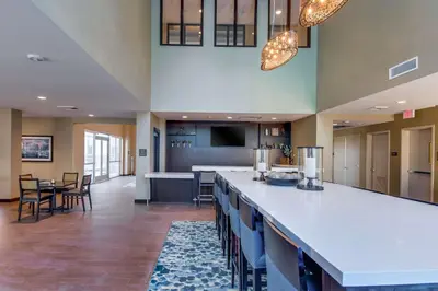 a large lobby with a bar with chairs and a kitchen at Hampton Inn & Suites Los Angeles - Glendale in Glendale