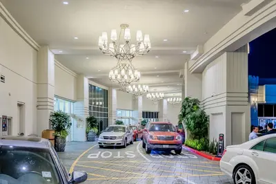 a large building with cars parked in a parking lot at The Commerce Casino & Hotel in Commerce