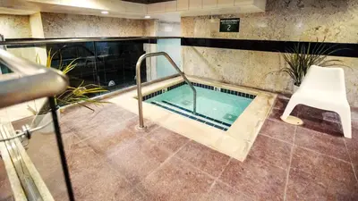 a hot tub in a room with a white chair at The Commerce Casino & Hotel in Commerce