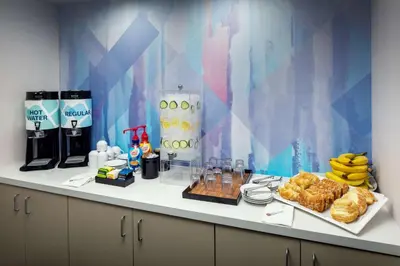 a breakfast table with food and drinks on a counter at Hilton Garden Inn Arcadia/Pasadena Area in Arcadia