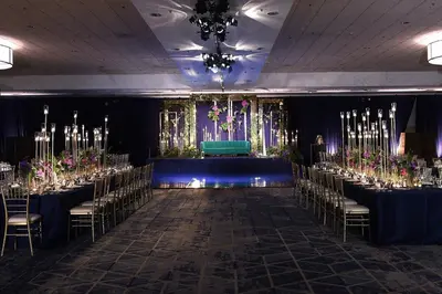 a banquet hall with long tables and chairs with flowers at Delta Hotels by Marriott Anaheim Garden Grove in Anaheim