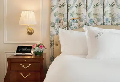 a hotel room with a bed and a table with a laptop at The Peninsula Beverly Hills in Los Angeles