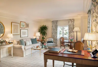 a living room with a couch and a table at The Peninsula Beverly Hills in Los Angeles