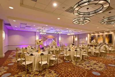 a banquet hall with tables and chairs in a room at Holiday Inn Long Beach - Airport by IHG in Long Beach