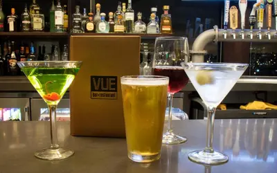 three glasses of drinks sitting on a bar at Holiday Inn Long Beach - Airport by IHG in Long Beach