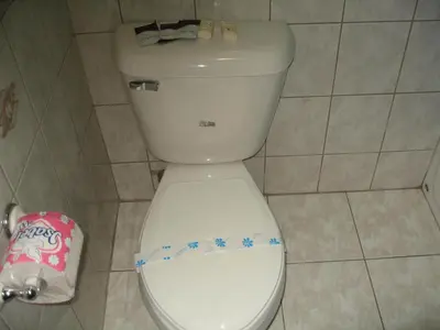 a white toilet in a bathroom with stars on it at Royal Inn Motel Long Beach in Long Beach