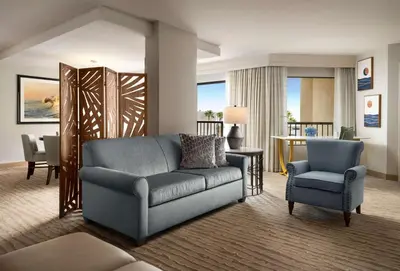 a living room with a couch and a chair at Sonesta Redondo Beach and Marina in Redondo Beach