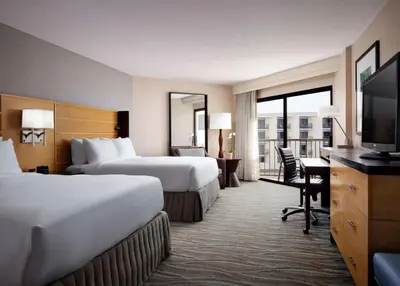 a hotel room with two beds and a flat screen tv at Sonesta Redondo Beach and Marina in Redondo Beach