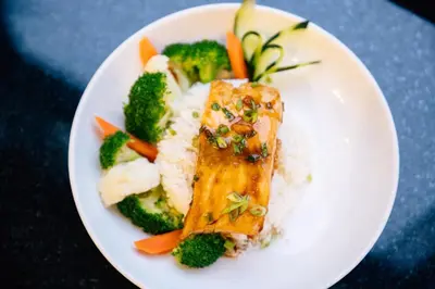 a white plate of food with rice and broccoli at Holiday Inn Los Angeles Gateway-Torrance by IHG in Torrance