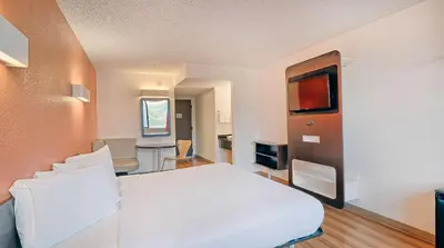 a bedroom with a white bed and a television at Motel 6-Los Angeles, CA - Los Angeles - LAX in Inglewood