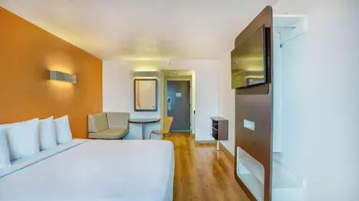 a hotel room with a white bed and a desk at Motel 6-Los Angeles, CA - Los Angeles - LAX in Inglewood