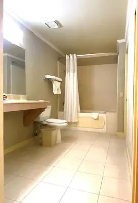a bathroom with a toilet and a shower at Ramada by Wyndham Los Angeles/Wilshire Center in Los Angeles