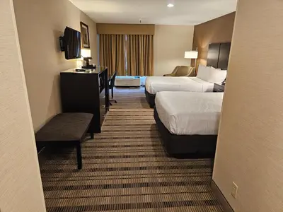 a hotel room with two beds and a desk at Best Western Pasadena Royale Inn & Suites in Pasadena