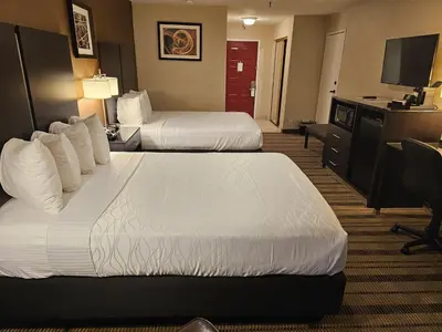 a hotel room with two beds and a television at Best Western Pasadena Royale Inn & Suites in Pasadena