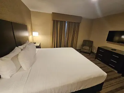 a hotel room with a large bed and a television at Best Western Pasadena Royale Inn & Suites in Pasadena